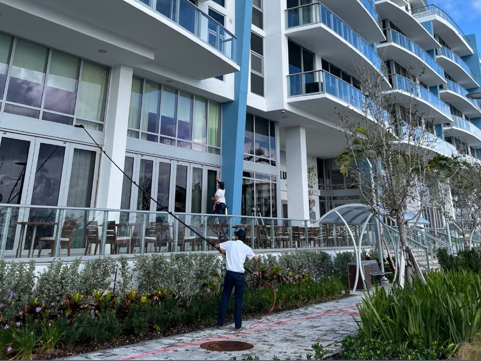 Pink's Windows crew using a water-fed pole on a Florida high-rise condominium